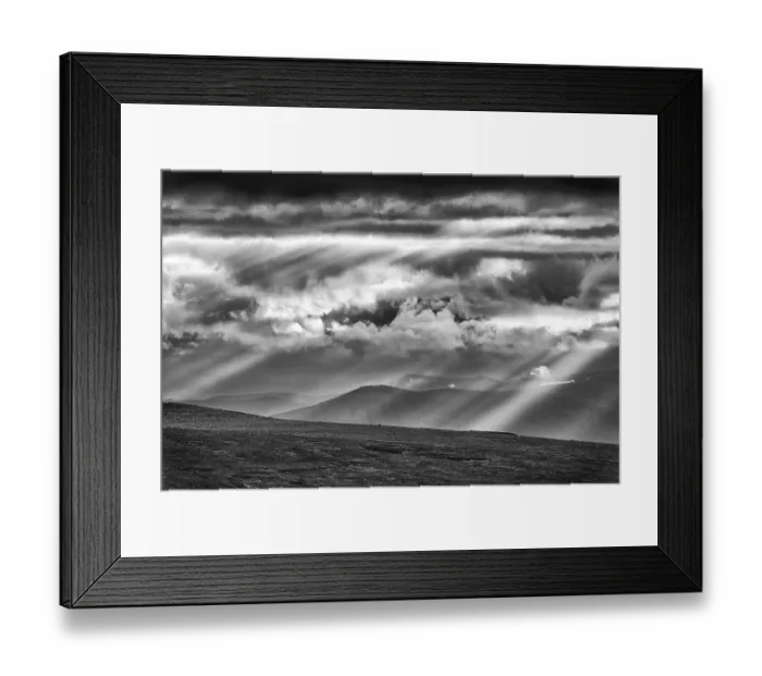 Framed Print : Sun rays fall through clouds in mountain landscape