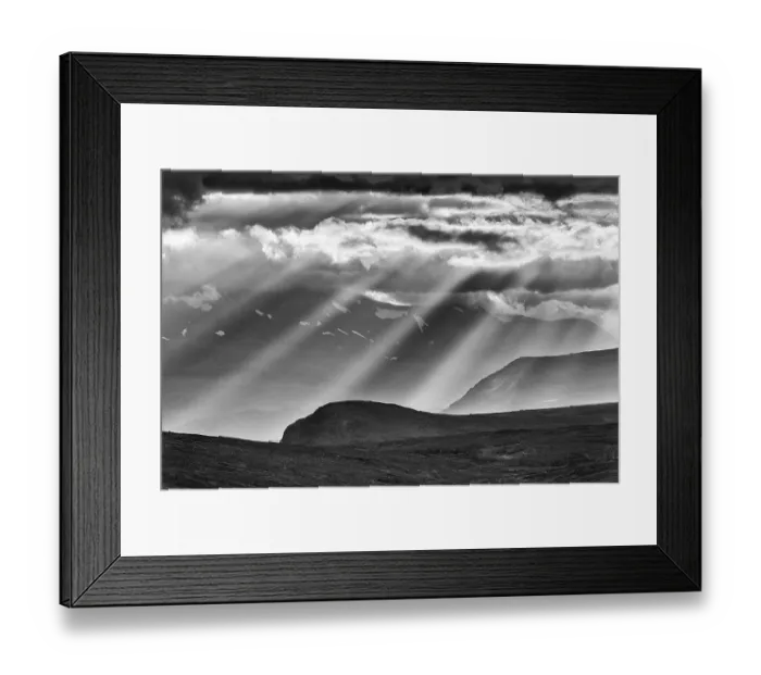 Framed Print : Sun rays fall through clouds in mountain landscape Framed Print : Sun rays fall through clouds in mountain landscape
