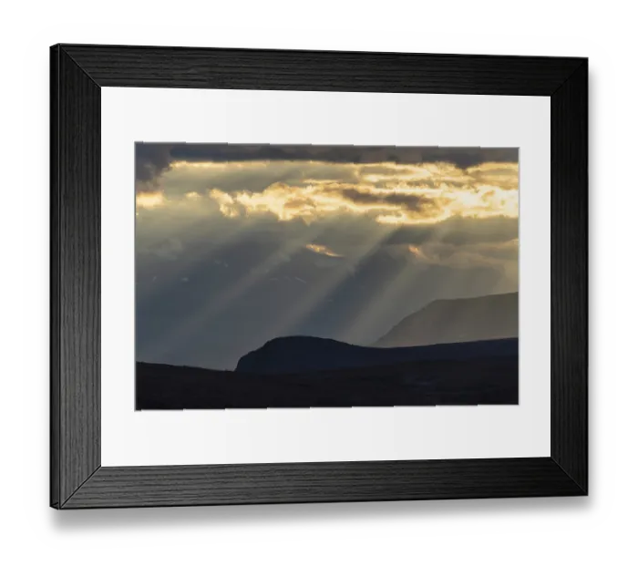 Framed Print : Sun rays fall through clouds in mountain landscape Framed Print : Sun rays fall through clouds in mountain landscape