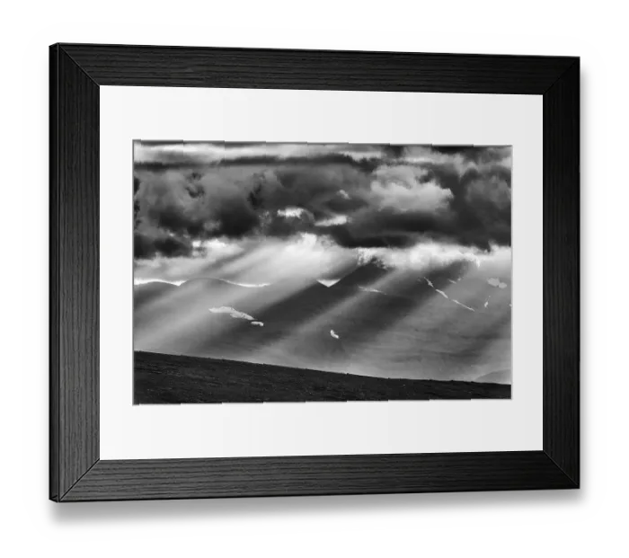 Framed Print : Sun rays fall through clouds in mountain landscape Framed Print : Sun rays fall through clouds in mountain landscape