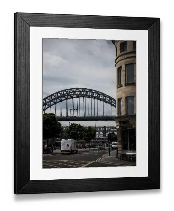 Framed Print : An urban scene with an arch bridge over a road