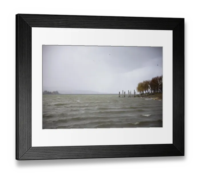 Framed Print : A windy, cloudy seascape with jetty and birds in the sky