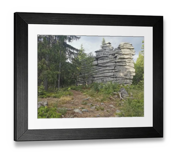 Framed Print : Large rock formations surrounded by trees and vegetation in a forest