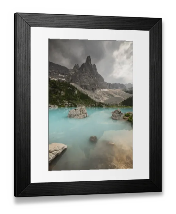 Framed Print : A dramatic mountain scene with a turquoise lake (Lago di Sorapis) and rocky formations under an overcast sky Framed Print : A dramatic mountain scene with a turquoise lake (Lago di Sorapis) and rocky formations under an overcast sky