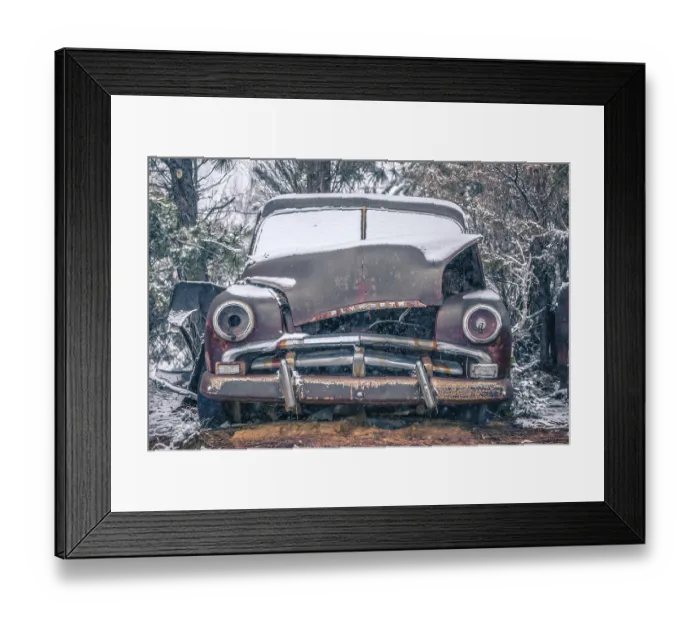 Framed Print : Old vintage plymouth automobile in the woods covered in snow