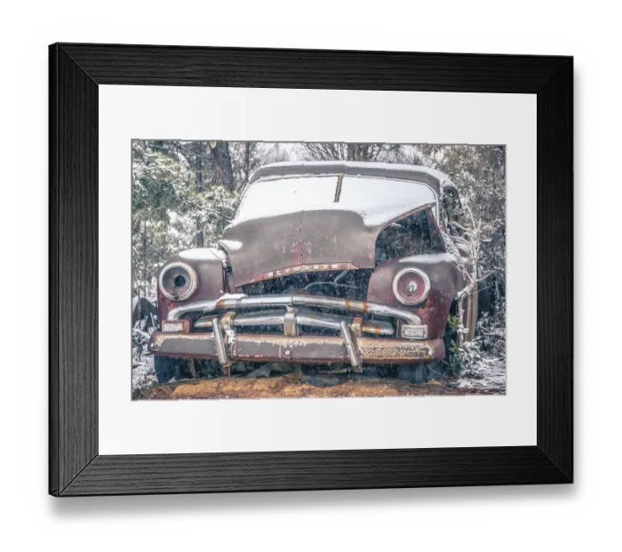 Framed Print : Old vintage plymouth automobile in the woods covered in snow