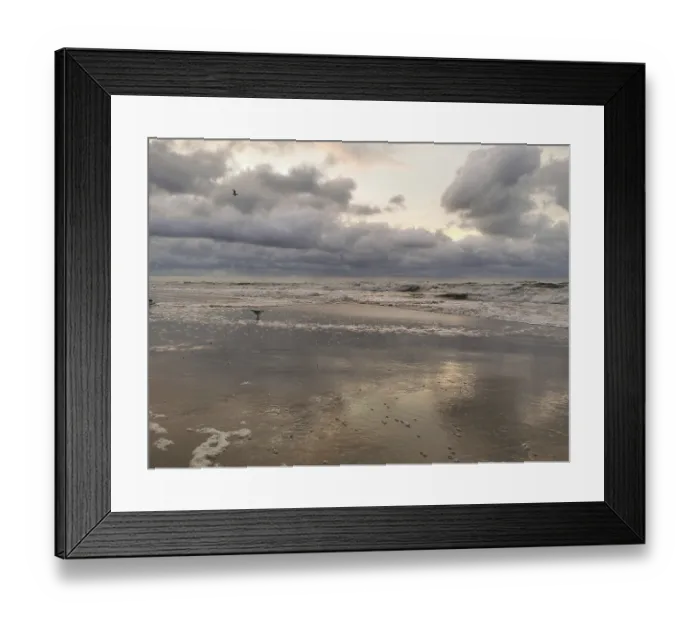 Framed Print : Seagulls fly over the waves of a stormy sea at dusk