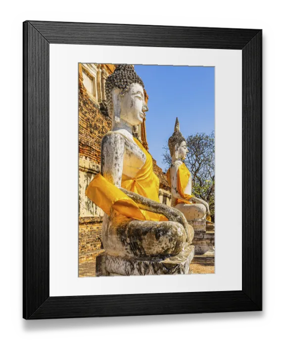 Framed Print : Stone Buddha statues decorated with yellow cloths
