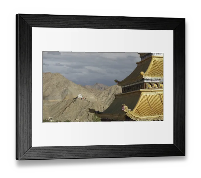 Framed Print : Roof of a Tibetan Buddhist temple with mountain backdrop and dramatic sky Framed Print : Roof of a Tibetan Buddhist temple with mountain backdrop and dramatic sky