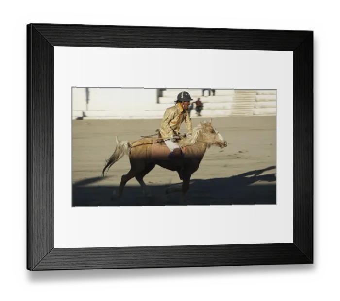 Framed Print : Single rider on horseback playing polo in traditional clothing on a horse moving
