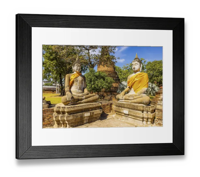 Framed Print : Stone Buddha statues decorated with yellow cloths