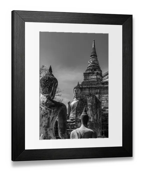 Framed Print : Stone Buddha statues, a temple tower in the back
