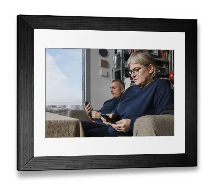 Framed Print : A senior couple sits in their cozy living room Framed Print : A senior couple sits in their cozy living room