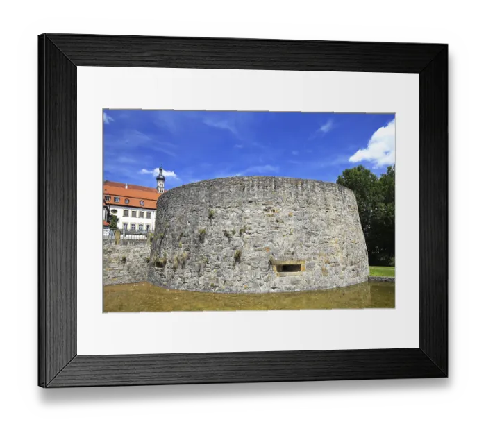 Framed Print : Stony bulwark tower with historic building in the background