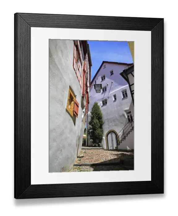 Framed Print : Narrow alley with half-timbered houses and nostalgic lantern under blue sky in Bad Wimpfen