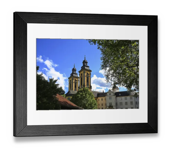 Framed Print : Baroque churches with twin peaks and surrounding trees in historic town