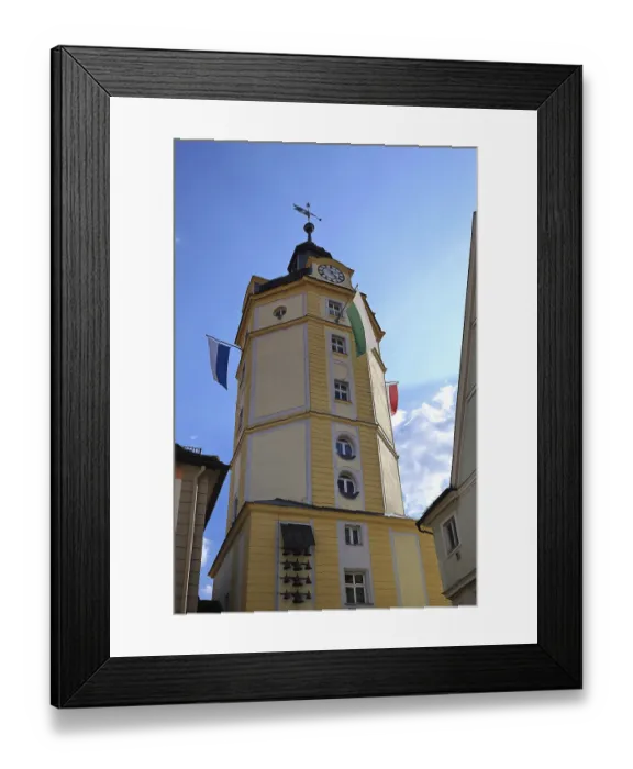 Framed Print : Yellow tower of the Herrieder Tor with flags under a blue sky Framed Print : Yellow tower of the Herrieder Tor with flags under a blue sky