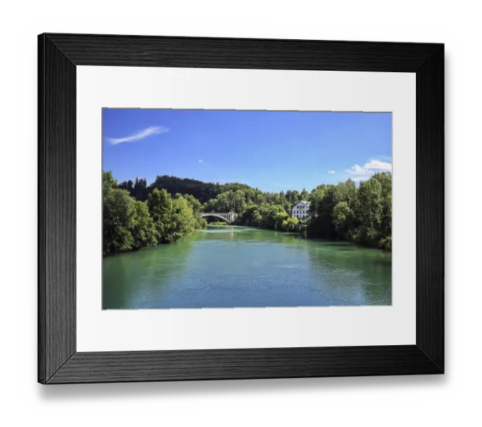 Framed Print : View of a historic railroad bridge over a river in wooded surroundings