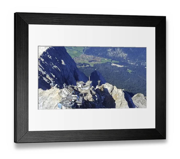 Framed Print : View from above of Zugspitze with a village and green fields in the background