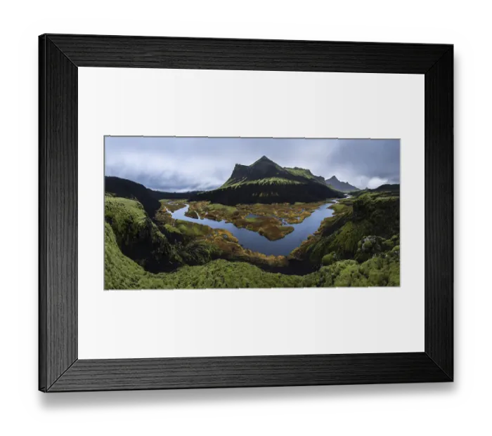 Framed Print : A stunning panoramic view of a moss-covered volcanic mountain with a winding river Framed Print : A stunning panoramic view of a moss-covered volcanic mountain with a winding river