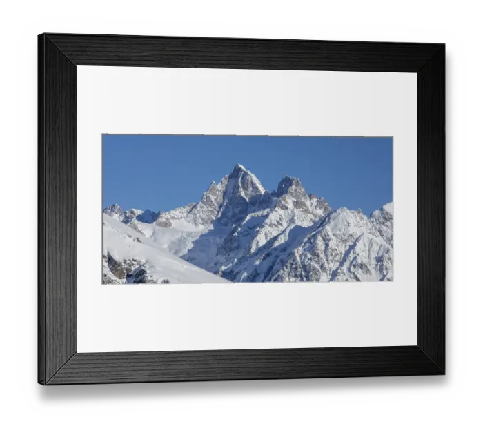 Framed Print : Majestic snow-covered mountain peaks rise against a clear blue sky Framed Print : Majestic snow-covered mountain peaks rise against a clear blue sky