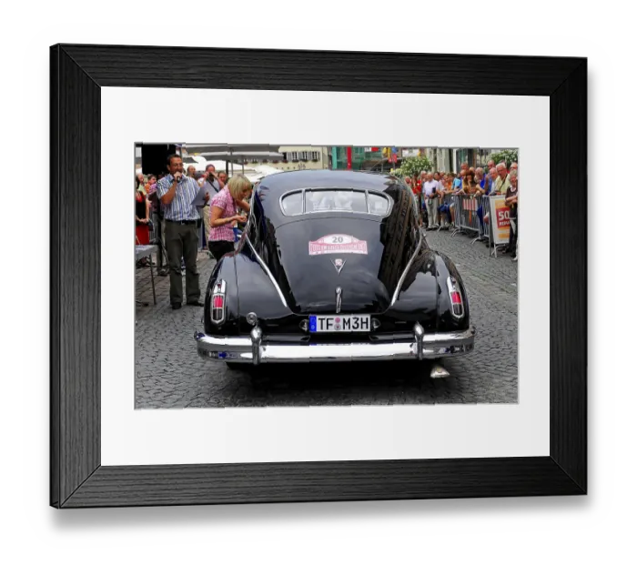 Framed Print : Rear view of a black classic car surrounded by crowds Framed Print : Rear view of a black classic car surrounded by crowds
