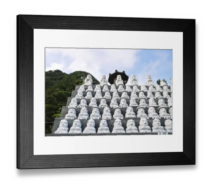 Framed Print : Dol Harubang and Buddha sculptures lined up in a row at Sanbanggulsa temple