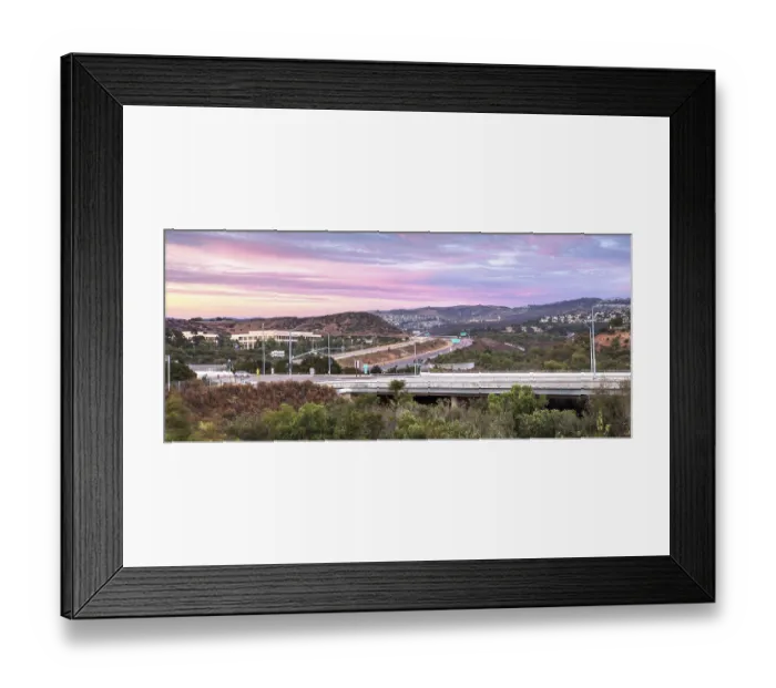 Framed Print : Highway in Irvine, California, at sunset with mountain range in the distance in summer