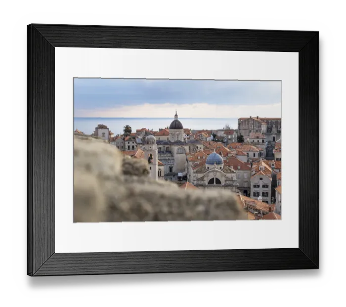 Framed Print : View over the roofs of old town Dubrovnik with church towers and ocean behind a stone wall in winter