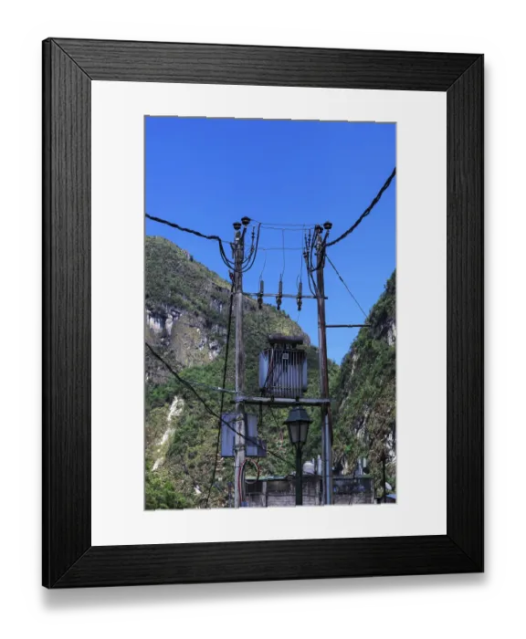 Framed Print : Transformer on a pole on a background of mountains Framed Print : Transformer on a pole on a background of mountains
