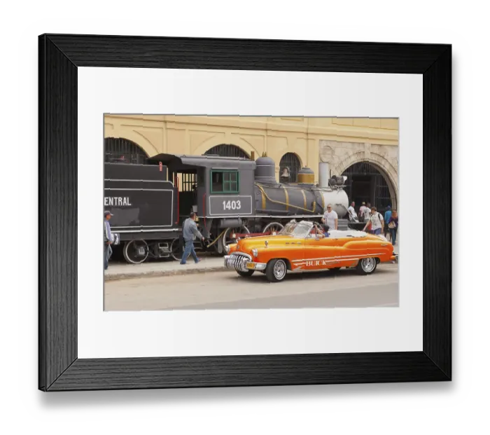 Framed Print : Havana Cuba february 2012 a typical Cuban cabriolet passes in front of the old steam train on display near the harbor Framed Print : Havana Cuba february 2012 a typical Cuban cabriolet passes in front of the old steam train on display near the harbor