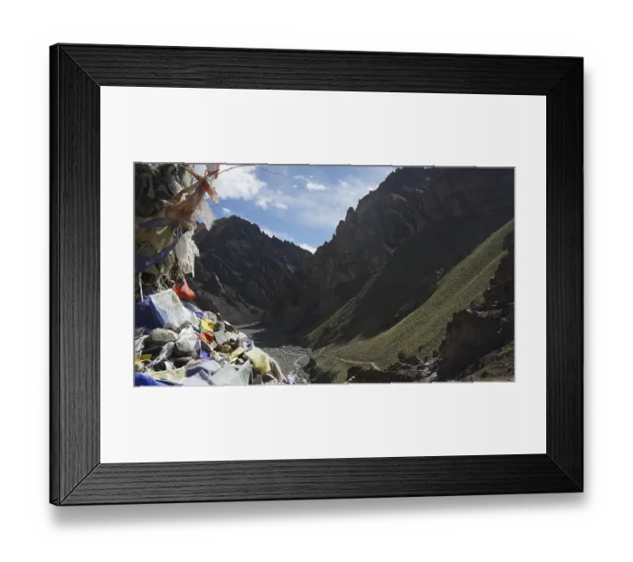 Framed Print : Mountain valley with prayer flags and dry riverbed surrounded by shady mountains