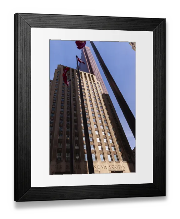 Framed Print : Tall building with flags against a clear blue sky in a city environment in Toronto