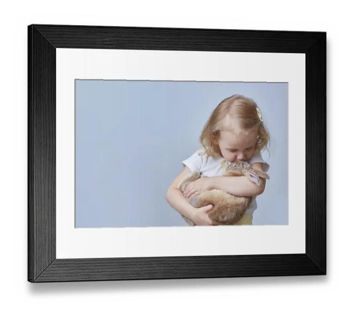 Framed Print : Cute girl hugs and kisses a rabbit Framed Print : Cute girl hugs and kisses a rabbit