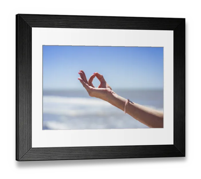 Framed Print : Close up of a mid-adult woman hand performing the Gyan Mudra at the beach Framed Print : Close up of a mid-adult woman hand performing the Gyan Mudra at the beach
