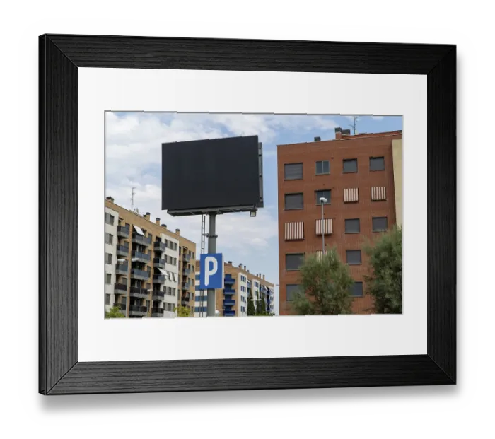 Framed Print : A large, blank advertising billboard stands prominently before residential buildings in Madrid