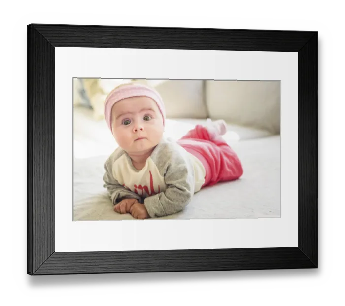 Framed Print : 6 months old baby girl lie on a couch in bright sunny living room