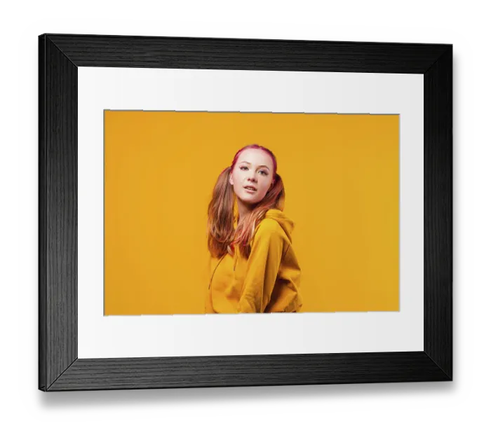 Framed Print : Cool young woman posing in yellow hoodie