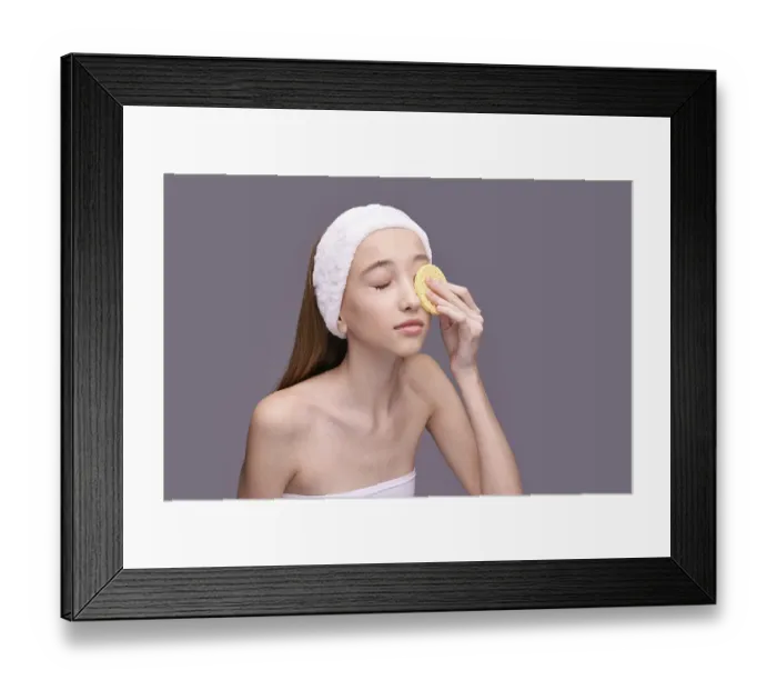 Framed Print : Young caucasian female applying skincare with sponge headband relaxation beauty routine Framed Print : Young caucasian female applying skincare with sponge headband relaxation beauty routine
