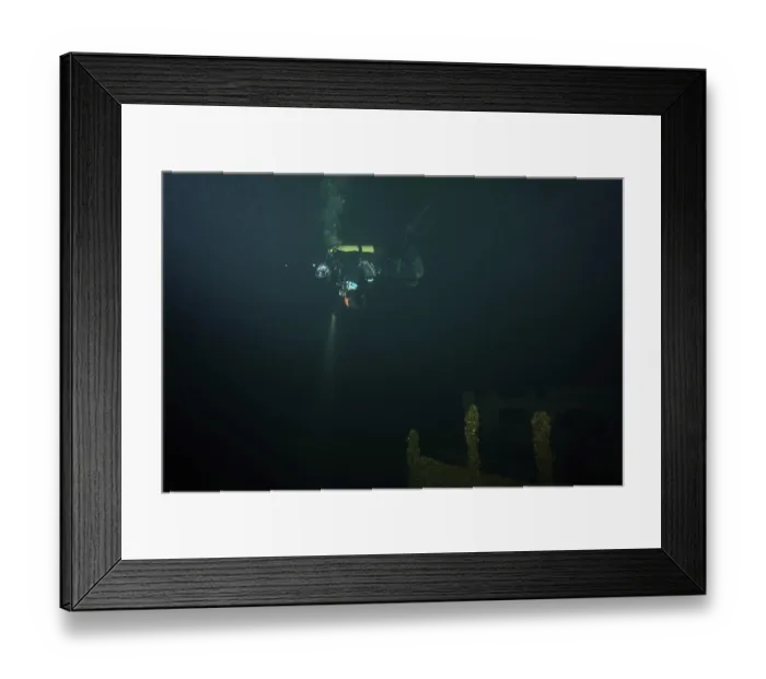 Framed Print : Diver in the dark over a shipwreck covered with mussels Framed Print : Diver in the dark over a shipwreck covered with mussels