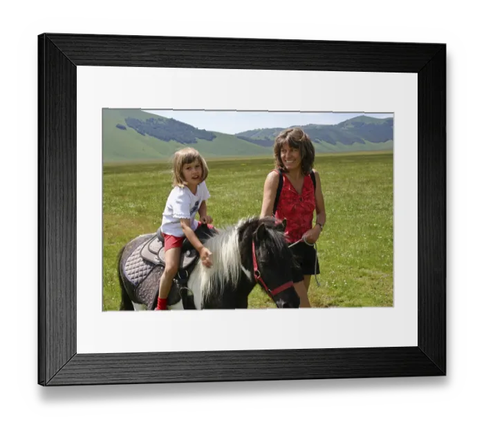 Framed Print : Mother next to daughter riding a pony
