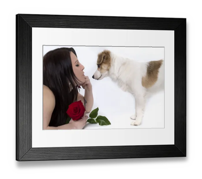 Framed Print : Young woman with a puppy holding a red rose