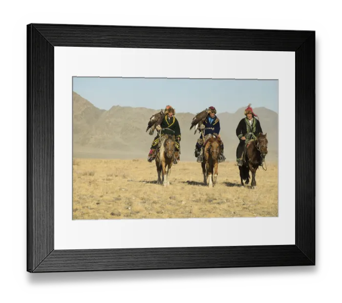 Framed Print : Three Kazakh eagle hunters on their horses on the way to the Eagle Festival in Sagsai