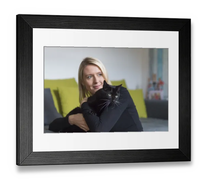 Framed Print : Young woman holding a black cat in her arms Framed Print : Young woman holding a black cat in her arms