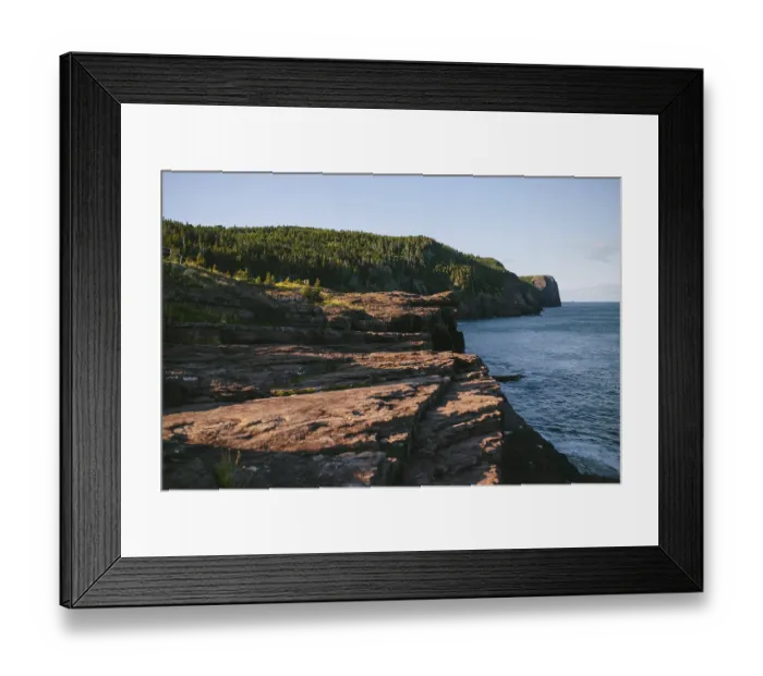 Framed Print : A serene view of the rugged cliffs descending into the ocean at Flatrock