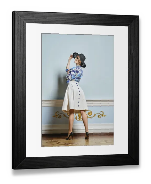 Framed Print : Pretty girl in broad brim hat, blouse and skirt with buttons in stiletos twisting near the wall Framed Print : Pretty girl in broad brim hat, blouse and skirt with buttons in stiletos twisting near the wall