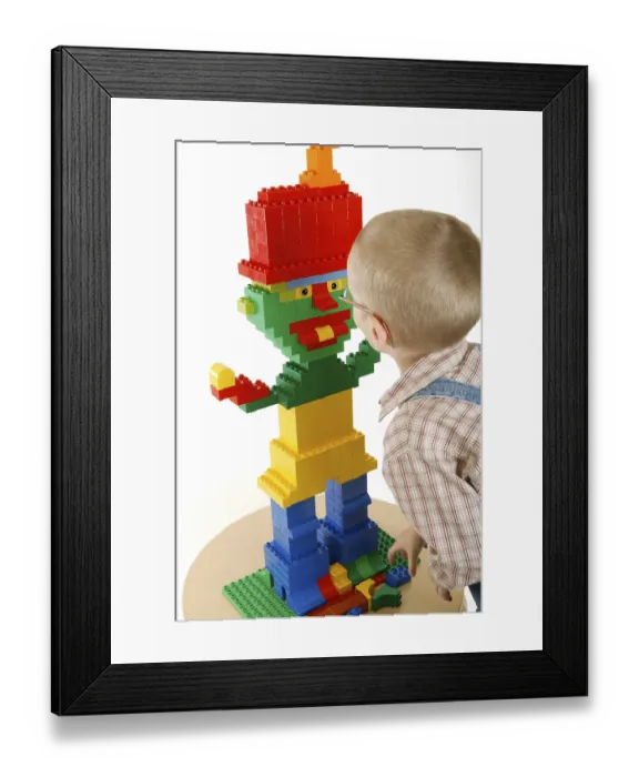 Framed Print : Little boy playing with bricks