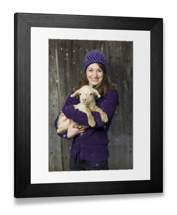 Framed Print : Woman holding a lamb in her arms
