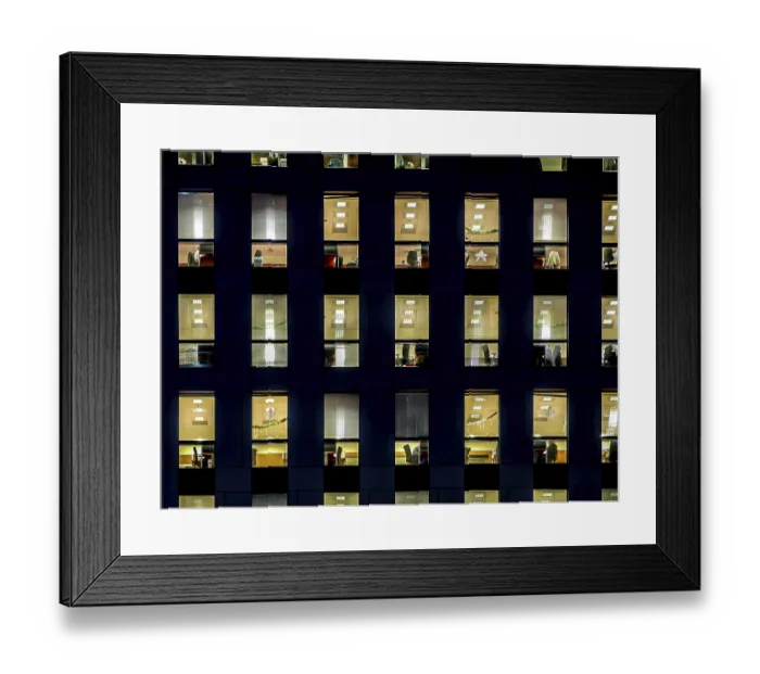 Framed Print : Corporate building exterior in the late eveing with interior lights