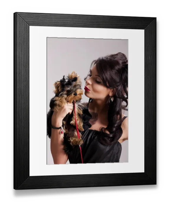 Framed Print : Young beautiful brunette woman in a black dress with a Yorkshire terrier